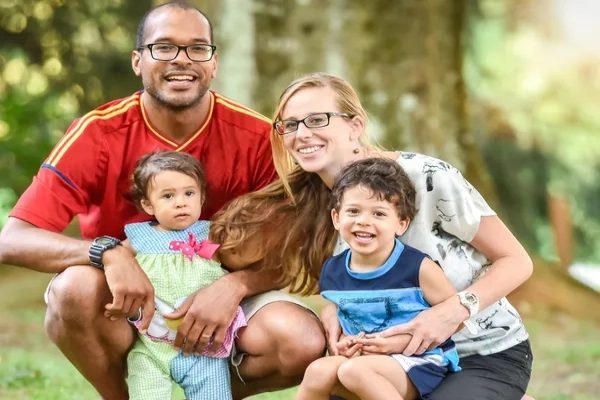 Family enjoys time together in the park, celebrating healthy and connected communities.