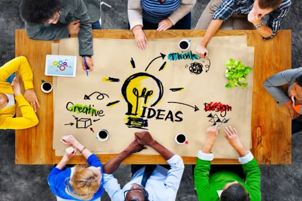 Team collaborates around creative ideas to develop impactful community programs.