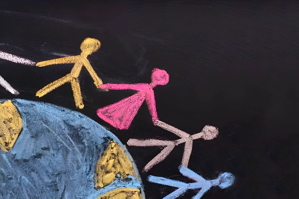 Chalk figures hold hands around Earth, representing global unity and shared humanity.
